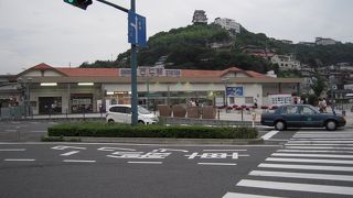 可愛らしい駅舎は海のそばで島に行くには便利だが、反対側はすぐ山