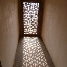 透かし彫りの窓から差し込む光で足元に浮かぶ幾何学模様。