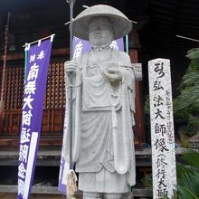 本堂手前の弘法大師（修行大師）立像。