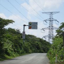 県境です。手前にゲート、送電鉄塔付近右側に駐車場が有ります。