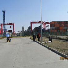 コンテナが近くに見えるバス停。何も無く何処がバス停か不明。