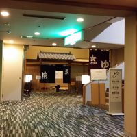 8階の大浴場入り口、更にエスカレーターで日帰り入浴施設に行く