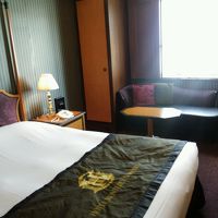 ベッド。窓際にはソファーとテーブルもあります