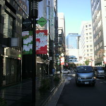 花椿通りの標識、のぼりと車の通る花椿通りの様子です。