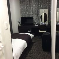 モダン綺麗な室内。机上には生花のチューリップ一輪飾られていた