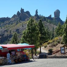無料駐車場脇の移動式売店とヌブロ岩。登山道起点も見えています