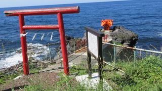 小さな祠（ほこら）が龍神の岩の上に建てられて、小さな橋がかかっている.