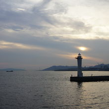 クルーズ船から　夕日が灯台の先に見える夕景色