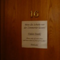 部屋のドアには「靴はドアの前で脱いでください」の張り紙