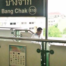 ＢＴＳバンチャック駅の標識と背景の緑の多い街並みの様子です。