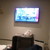 テレビは壁に掛かってます。その下にテーブルとイス。