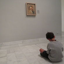 座り込んでデッサンする少年。