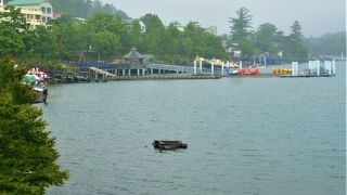 温泉で新緑の湖岸が一面の中禅寺湖 
