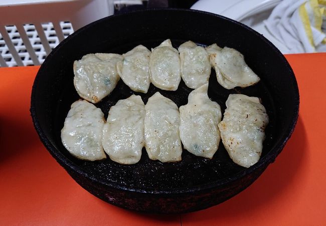 熱々の鉄板でだされる焼き餃子。皮がモチモチ、ギョウザの底がカリカリな食感。