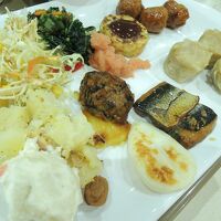 ブッフェ式の朝食　料理をお皿に盛りつけ