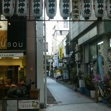 アーケード街から細い路地に入った奥にある神社。入口には提灯が