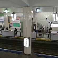 ホーム頭上の円錐形のシャンデリアと和風デザインの照明灯