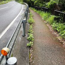 看板の前にトローキの滝へと続く細い道があります