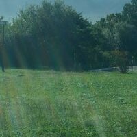 客室からの眺望は、牧草地や森の向こうに斜里岳が聳える