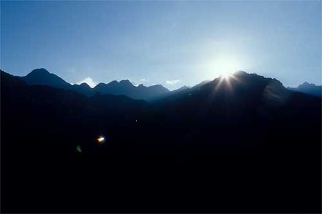 マチュピチュ→クスコ<br /><br />５月２５日（水）晴<br /><br />６時過ぎ厚着をして公園に入る。もう遠くまで歩くのはいやなので、ワイナピチュが見えるところで朝日が当たるのを待っている。Papasanはもう少し上にのぼってスケッチをしている。インカ道を歩いてくるトレッキングの人たちが入ってくる。太陽はすでに上がっているのであたりは明るいが、高い山に囲まれているこの谷にはまだ光は射さない。日本人客が入ってきた。一番のバスで上がってきたのだろう。気がつかなかったが、ワイナピチュの頂上近くに工事用の青いシートが張られている。<br /><br />7時、ワイナピチュの頂上に日が当たった。そして少しずつ面積を広げていく。光があたり始めるといつしか青いシートは見えなくなった。ちょうど目の前の高い峰から朝日が上った。エリアカシトドがさかんにさえずっている。<br /><br />食事に帰る。珍しくヨーグルトがあった。部屋に戻り、庭に出てみた。庭はきれいに花が植えられ、水路から滝も落ちている。散歩が出来るように小道が裏の林に続いている。野鳥がいっぱいやってきている。<br /><br />９時、待ち合わせの時間なのでフロントに下りていく。ミチコさんはもう来ていた。荷物を預け、公園に再び入る。お別れにゆっくりと人気のない路を歩く。<br />少し早いけどアグエス・カリテンテスに下る。のぼりのバスは満員だが、帰りのバスは少ない。下るまで何台のバスとすれ違っただろうか。乗客３０人とみても１０台はくだらないのではないだろうか。いくら広い遺跡でも、遺跡が満員になりそうだ。<br /><br />食事は１２時とのことで、アグエス・カリエンテスの町を歩く。土産物屋がぎっしり。絵葉書を買った。学校の傍に文化会館があったのでのぞいてみる。遺跡の写真や動植物の写真が並んでいる。<br /><br />広場にはインカ皇帝の銅像が建っている。早めにレストランに入る。レストランはウルバンバ川を臨んで建てられている。川の上は切り立つような崖、寄生植物のプラメリアがいっぱいついている。鳥たちが木の間を移動しているのはわかるが、ちょっと遠いのでどんな鳥なのかは判断できない。<br />食事はブッフェ方式。デザートにグラナディアを４ケも取って来て、後で食べようとバッグに入れた。<br /><br />ちょっと上りはきつかったけど鉄道の待合室に行く。きれいな待合室だ。やがてここが駅になるようだ。<br />列車が来た。今度は来たときの反対側、川沿いの席だ。キヌアの畑、とうもろこしの畑、そう、山にはユーカリが植えられている。インカ道が谷に沿うようにつけられているのがわかる。<br /><br />車内販売が来た。マチュピチュのカードがあったので、教室の子どもたちのために買う。８ドルだというので１０ドル出したら、ソルでおつりをくれた。<br />カードを見ていたＰapasanが「２１ソルって定価がついてる。ドルとソルとどっちが得なのかな」なんて言っている。それを聞きつけて前席のミチコさんが振り向いた。「何かお買いになりました？」「子どもたちにカードを。８ドルだというから１０ドル出したらこれだけお釣りをくれた」と言って見せると、ミチコさんはそのお釣りを持って、販売の女の子のところへいった。そしてお釣りを返した。「後でお釣りを持ってきます」「ここに21ソルって書いてあるんだけど」「２１ソルお持ちですか」「あると思います」といってpapasanが２１ソルを出すとミチコさんはそれを持って行ってさっきの10ドル紙幣を返してもらってきた。計算の弱い私にはさっぱり分からないのだけど、ボケボケしていてはいけないようだ。私はお金を持たないし、Ｐapasanは計算は強いほうなんだけどねぇ。<br /><br />オリャンタイタンボについた。アドルフォが待っていてくれた。クスコへの旅が始まる。ウルバンバまでは同じコース、インカランドはどこだとか、食事をした農家はあれだとか言っているが、やがて車は坂を登り始めた。登ると、そこは高原が広がっている。高原の向こうにチコン山塊が雪を頂いてこちらを眺めている。チコン山塊を写していると、赤ちゃんを抱いた少女がやってきた。子守をしているようだ。「写真を撮ってもいいか」と聞くとOK。少女の顔がとってもいい。お礼にアメをあげた。<br />ユカイの町やウルバンバ川の流れが望める高台には、客待ちの人形を売る子どもがいたが、買わずに車に乗る。こんな高原にも湖があり、畑があり、放牧が行われている。低いところにとうもろこし、高いところは麦や豆類を植えるのだそうだ。<br /><br />クスコが一望できるところで、車はストップ。ここでミスをした。フィルムが終わったので入れ替えようとしたときだった。巻き戻しの途中で蓋を開けてしまったのだ。しかも普通ならすぐふたを閉めてまき戻すのだが、なんとそのままフィルムを引き出してしまった。この中にはあの女の子の写真が入っている。さすがの私もすごく落ち込んでしまった。<br /><br />ホテルに着いた。７時４５分にミチコさんが迎えに来る。<br />さっそく部屋を温めようとしたが、部屋の暖房が効かない。フロントに言いに行くと、係りをよこしてくれた。係りは暖房のノブを回してOKだという。急いで触ったが温風は出ていない。「これでほんとに大丈夫なの？」というと「６分待って」と言って出て行った。６分待っても温かくはならない。もう一度フロントに言いに行き、私はフロントの横にあるPCで遊んで、もどると部屋の前に電気ヒーターが置いてあった。そこでそれを中に入れて、電気をつけた。むしろ風呂場は床暖房なのか暖かい。鼻風邪を引いてしまったので、なお寒気がするのだ。戸棚から予備の毛布を出して２枚かけた。それでも寒い。<br /><br />近くのレストランでフォルクローレ・ショー付の夕食。舞台のまん前といういい場所なのだが、風邪で鼻水が出てグシュグシュなので、いまいちのれない。店内の半分は日本人が占めている。とにかく寒い。アルコールを飲めばいいのだが、目下禁酒中。ここではトマトソースのことをナポリタンというのだそうだ。そこでスパゲッティ・ナポリタンをとったが茹ですぎで美味しくない。フォルクローレ・ショーもおもしろくない。明日は聖ドミンゴのお祭り、広場は飾りつけがされているようだったが、もう限界だと、そのままホテルに戻り、洗濯をして、診療所で貰った風邪薬があったので、それを飲んで、早々に寝てしまう。<br /><br />
