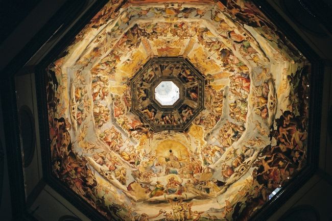 　2000年のミレニアムの年、ミラノ、ベネツィア、フィレンツェ、ローマのイタリア四都市周遊の旅に出かけました。<br />　フィレンツェでのその日の観光は、午前ウッフィーツィ美術館、昼食をはさんで午後の自由時間は、真っ先にフィレンツェの象徴「花の聖母寺院 Duomo」へ行きました。友人は映画「冷静と情熱・・」がらみで興奮していましたが、そういう友人を尻目に、正直なところ、自分はもっと高尚な気持ちで登りたいと思っていたのでした。<br />　六月のフィレンツェの太陽は、およそ３０分の待ち時間の間、ジリジリと容赦なく照りつけていました。階段は幅が狭くて、勾配がきつく、ワンピースを着て来たことを非常に後悔しました。途中休み休みしながら上を見上げると、天蓋の壮大な壁画がだんだん近くに迫ってきて、圧倒されるような、こわいような気がしてきました。間近で見る最後の審判は、人を吸い込んでしまうような”深い”ものでした。創造力、背景にある思想、それを表す表現力に感動を覚えました。その印象が心にしっかりと刻まれるよう、一歩一歩ゆっくりと歩を進めました。<br />　天蓋の外に出ると、レンガ色の美しいフィレンツェの風景が一面に広がっていました。涼しい風が吹きぬけてとても気持ちが良かったです。アメリカから来た青年、ドイツ人のグループなど皆少々汗ばんで、しかし一番高いところまでやってきた充実感でちょっぴりいい顔でした。