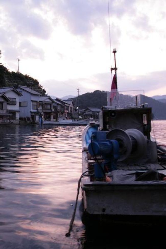 天の橋立を素通りし、丹後半島を宮津湾沿いに北上。憧れの伊根湾に近づきました。目指すは舟屋の里と呼ばれる京都府伊根町。<br />舟屋とは船揚げ場や物置、作業場を兼ねた海辺の2階建ての建物。昔から連綿と受け継がれてきた独特の建物です。伊根湾の切り立つ断崖の海辺に、5kmにも渡って230軒あまりの舟屋が並ぶ風景を、ひと目見たくてやってきました。日没近し・・。<br /><br />写真は、伊根の舟屋につながれた漁船。