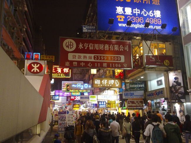 香港で最後の宿Ibis・・エビスではございません、イビスです（汗）・・・にチェックイン、荷物を置いて身軽になったワタシは、ふたたび地下鉄に乗ってお目当て九龍半島のモンコック（旺角）一帯を目指す。<br /><br />今回の香港旅行、いやホンマに「リョコウ」なの？・・展示会見て、電脳街見て帰るだけやん・・・これって、つまり、要するに、全国のマニアックな少年少女たちが東京ビッグサイトで開かれるコミックの祭典を見て、あとはアキバ行って・・・つーのとホトンド同じようなものでは。。。。<br /><br />いいんです。<br />今回さいごのミッションは、いつでもどこでも一緒の愛人、もとい「愛機」を探すということだったのですから。<br />しかも条件は、シンビアンなノキアちゃんやサムソン号、蒼井優が日本でも宣伝しているエルジーなどではなくて、『アンドロイド』であること！　・・・いや実にアキバちっくな響き。。。意味わかんない方は飛ばしていただいて（笑）（汗）<br /><br />・・・<br /><br />いたるところに「電脳城」がある香港の中でも、地下鉄の旺角駅周辺はケータイのショップが中心、その品揃えは香港のケータイというよりは中国本土でも見るような少々怪しげなヤツから、果てはどっかで見たような、iモードだの Yahoo携帯の改造版まで・・これまた怪しいが店員に聞けば「日本から輸入」して、みごと現地適合品として改造されとります・・・もちろん正統派北欧系ノキアも。そういう「聖地」がここ、「先達廣場」。ビルの中は１坪２坪の零細ショップが密集する。<br /><br />・・・てか上の看板がデカすぎて、「広場」が全然目立たないって。。（笑）<br /><br />この日は日曜日、大通りから入ったところは歩行者天国になっていてモノスゴイ人出。<br />マニアなくせに、いざ買うとなるとどうしても「マトモ」なショップできちんとパッケージングされた「製品」が欲しくなるワタシ、この周辺にもたくさんある電器店やキャリアのショップをぶーらぶら。<br />香港の展示会のあとで香港在住「リュウさん」に案内してもらった大手「BROADWAY」で品定め。HTCの「TATTOO」を手にとって、こりゃいいな、値札は2998香港ドルとあるがまだ下げますと・・・イクラ？と聞けば2698ドル。先達だと同じ機種が2000ドルも切って1800とかなんだけど、こちらは純正新品だから、リスクは低い、よっしゃ買う！と言えば店員のお兄さんはおもむろに端末を叩いて在庫チェック。５分待たされて・・・申し訳なさそうな表情になったお兄さんが小さな声で、NO INVENTORY・・・<br /><br />「在庫がアリマセン！」って。。。<br /><br />こうしてフラれるとますますモエ上がるのが男の性ってやつ？、よーし、どっか他に当たればあるだろう！と、「タトゥーのアンドロイド」を探して次の量販店へ。値札は同じ2998香港ドルだが、これいくらになるの？と聞けば2680香港ドル。ほんのキモチ安くなってるがそれはモンダイじゃなく、「買い～！」再び店員が「在庫をチェックします」・・・まさか同じ所に照会してるんじゃ、だとしたらこの機種はもう無い・・・１０分待たされジリジリしてきたところへ、担当店員に携帯パッケージを渡す別のオトコ、「キター！」<br />店にはHTC社の販促員がいて、「韓国？日本から？・・・」「日本人デス」「日本は携帯モノスゴク進んでるよね。日本メーカー技術が進んでるからHTCもなかなか売れない」・・・いいえ、日本はガラパゴスなんです。世界で売れてるのは韓国製ケータイやおたくの、HTCだって、わかってますから。<br />ほらね。<br /><br /><br /><br />気がつけばもうすっかり日が暮れてしまった。旺角一帯はこのほかにスポーツ用品やシューズの店も多い。<br /><br /><br /><br /><br /><br />この猥雑な雰囲気、香港らしくて、個人的には好きだ。<br /><br />観光のようで仕事のような、いつもと違う香港と初めての深セン＆東莞。<br />もう思い残すことはアリマセン。<br />いや最後にひとつだけ。<br />香港人も好きだといってた「福建炒飯」だ。今日のお昼までと違って１人だし、良いレストランに入っても寂しいだけなんで・・・（涙）<br /><br />ホテルのすぐ近くには庶民的な食堂があって、実に豊富な漢字メニューの中に「福建炒飯」をめざとく見つけた。３４香港元なーり。<br />「フッケンチャ～ファン」・・・店のオバちゃんに通じたらしい。<br />どう見てもニッポン人旅行客とは見られなかったらしいのは、買ったばかりのケータイの他にもっていたのが中国語（簡体字）版の香港観光地図だったからデスかね。。<br />やがて運ばれてきた、具だくさんの「福建炒飯」・・・この「定番」の、アタリマエすぎるあんかけチャーハンで、食べまくり旅行を締めくくるのも悪くなかったと思います、ハイ。<br /><br />名残惜しいが、スーパーで買った青島ビールを１リットルばかり飲み干して就寝。（笑）<br /><br />～ZZz ZZz～<br /><br />翌朝６時すぎ、地下鉄の始発に乗って中環で下り、香港站でインタウンチェックイン。<br />ほとんど手ぶら同然で来た香港空港。いつものようにキレイだ。<br /><br />ノースウェストあらためデルタ航空ホノルル行き。<br />残念ながらワタシは東京で降ります・・・<br /><br />機内食の朝食を食べながら、リュウさんの言葉を思い出した。<br />「いや～、こっち（香港中国）いると舌が肥えちゃってね～」<br />えぇ、機内食がこんなに美味しくないものだとは・・・ね。<br />アジアはウマい。この「基本法則」を、再確認した香港、中国の５泊６日だった。<br /><br />最後になりましたが。<br />今回、香港で会社を経営しているリュウさんには、本当にお世話になりました。また、取引先のナンチャンにも、いろいろ教えていただきました。<br />まだ読んでいらっしゃるかわかりませんが、この場を借りて改めて、あつく御礼申し上げます。<br />