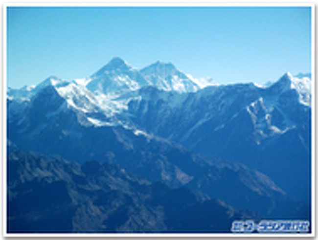 ネパールと聞いて何をイメージされますか。 <br />「ヒマラヤの山々」と答える方が多いのではないかと思います。それもそのはず。世界には8000ｍ級の山が14座ありますが、そのうちの、なんと８座がネパールにあり、まさにヒマラヤの国と言えるのです。 <br />ヒマラヤといえば、今はやりの山ガールというわけではございませんが、登山を楽しむイメージが強いです。しかしながら実は山々をうんと近くで見ることが出来る遊覧飛行にトライしてきました。<br /><br />遊覧飛行では、ホテルのお庭から、ハイキングで歩いている最中、下から見上げていたヒマラヤの山並みを目の高さ、もしくは眼下に臨む事が出来、スケールの大きな山並をたっぷりと楽しむことが出来ました。 <br /><br />アンナプルナの遊覧飛行は、ヒマラヤの懐の街ポカラから早朝に出発します。<br />薄暗い曇り空のため、天候が整うまでの間、空港にてしばし待機。この待ち時間の間、雲が晴れて山が見えるかどうか期待と不安で胸が高まりました。 <br />いよいよ飛行機に乗り込み、いざ出発。プロペラは大きな音を立てて回り始め、その振動が体中に伝わると同時に高鳴る胸の鼓動が耳に聞こえるような気がしました。<br />飛行機が滑走路から飛び立ちポカラの大空へ！<br /><br /><br /><br /><br />幾つかの雲を越えると、そこにはスカイブルーの空が広がっていました。ポカラの街が小さくなるにつれ、朝日に赤く照らされて輝くヒマラヤ山脈の頂が、どんどんと近付いてきます。 <br />窓の外をのぞくと目の高さに、ダウラギリ（8167ｍ）が。サンスクリット語で白い山という意味だそうですが、その名にふさわしい姿でした。<br />飛行機の窓には次々と白き山々の頂きが現れます。アンナプルナ?（8091ｍ）や、魚の尻尾のような形をしているマチャプチャレ（6997ｍ）、日本人によって初登頂されたマナスル（8156ｍ）などの峰々を眼下に、そして間近に見ながら飛行機は進みます。 <br />遊覧飛行の間、今回は順番に前方の窓を覗かせてもらうことが出来ました。フロントガラスからの視界は横の窓からとはまた違う光景が目の前に広がります。青い空と白い雪を湛えたヒマラヤの鮮やかなコントラスト。どこまでも続くその様は、確かに神々が座するといわれてもおかしくはありません。<br /><br />約40分のフライトはあっという間に過ぎていき、我々はポカラへと降りていきました。後ろを振り返って見上げるとそこにあるヒマラヤの山々。ついさっきまであの近くを飛んでいたのに、いまやあんなに遠くに美しい姿で静かに座しているのが不思議で、そして離れるのが名残惜しい気持ちになりました。 <br />お天気や場所、時間によって様々な表情を見せるヒマラヤ。何度見ても見飽きることのない壮大な光景は、フレームに収めるには大きすぎてしまうのです。神々の座す山はこの地に、世界中の人々を惹き付けてやまないかぐわしい花のようです。 <br />神々の座する国ネパール。2月が近づくとネパールへ行きたくなります。<br />