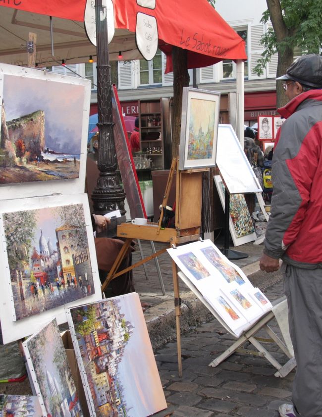 パリの休日　第2幕<br />モンマルトルのテルトル広場の画商　2011.10.26<br />Place du Tertre in Montmartre<br /><br />先に公開した「2011ヨーロッパ鉄道の旅12日間/概要」http://4travel.jp/traveler/810766/album/10617323/に続いて個別の都市ごとの旅日記に基づいた写真旅行記の連載を進めます。<br />第19回はモンマルトルのサクレクール寺院と似顔絵画家のテルトル広場です。<br />2011.10.26(水)昼<br />サクレ・クール寺院の周辺を往き来していろいろなアングルで写真を撮ったり、風景をながめたり、正面の階段を昇り下りしたりして思う存分モンマルトルを楽しんだ。<br />いったん寺院の前を離れ、西側にある似顔絵画家で有名なテルトル広場へ行ってみた。周辺のレストラン、カフェなども昼食時で賑わっており、画商の店先の様子や似顔絵作成中の姿などを写真に収めた。<br />そのあとは再び寺院の前へ戻り、正面の坂を下って見納めのサクレ・クール寺院を写した。<br />1965年以来何度か来たこの場所は今回が最後になるかもしれないという思いが往き来し、ちょっぴり感傷的になった。<br /><br />撮影　CANON EOS40D EFS 17-85,EFS 55-250<br />参考資料<br />昭文社　個人旅行21　パリ<br />RATP Paris(メトロ、バス、RER　路線図)<br />旅行記2011①～⑲は前記の概要編http://4travel.jp/traveler/810766/album/10617323/にURLの記載(ﾘﾝｸ）があります。<br />第19回公開　2012.03.17　<br />毎週土曜日に新編公開予定「土曜旅画劇場」（入場無料）<br /><br />お気に入りブログ投票（クリック）お願い<br />http://blog.with2.net/link.php?1581210