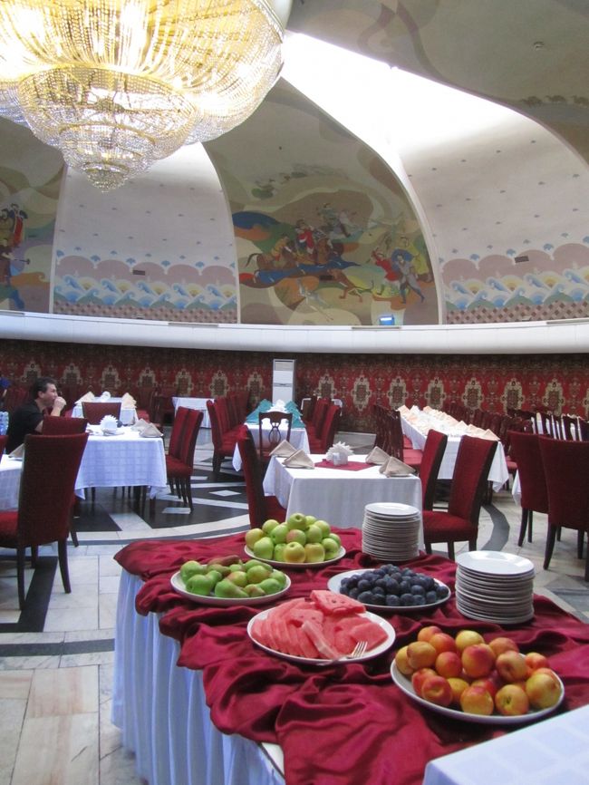 今回の中央アジア３ヶ国旅行のカザフスタン部分では、旧都アルマトイに２泊しました。<br />ホテルは、自分でBooking.comで探して予約しました。<br />Booking.comで検索すると、これが西欧のメジャーな都市、あるいは東欧でも人気のある都市となると、チェックするのがうんざりするほどたくさん予約可能なホテルがヒットすると思いますが、中央アジアとなると、数えるほどとなるので、チェックがラクです。<br />ただし、選択肢があんまり少ないと、ホテルサイトのネット予約があまり浸透していない懸念があり、予約サイトに頼ると、逆に良いホテルを逃しそうで心許なくなります。<br />でも、アルマトイくらいだと、条件に合うホテルはそこそこありました。<br />40数件ヒットしたので、価格とロケーションで10件ほどに絞りました。<br />旅の最後なので、少し予算を上げてもいいから、市内のみどころが徒歩圏内のがっつりセントラルで、観光の途中で気軽にホテルに戻れるくらい、そしてそれなりに快適なホテルをねらいました。<br /><br />というわけで、四つ星のホテル・オトラルにしました。<br />旧ソ連系で、日本人団体客もよく利用するということで、日本人観光客にとっては、アルマトイではメジャーな方のホテルだろうと思います。<br />日本人団体客もよく利用するのでは、面白みがないと思うこともありますが、中央アジアなら、アルマトイ観光する日本人観光客はもともと多くないので、逆にホテル選びの基準になります。<br />というのも、設備やサービスの快適さにおいて、日本の旅行代理店がお客さんを泊まらせるだけのレベルに達しているといえるからです。<br /><br />コスト・パフォーマンスは、どうでしょう。<br />石油大国のカザフスタンの中でも観光客がよく行くアルマトイは、ホテルの値段は中央アジアの中では高いようです。<br />また、中央アジアの旧ソ連圏のホテルのレベルは欧米や日本と比べるわけにはいきません。<br />Booking.comが総じてお得であることを信じ、予約可能としてヒットしたホテルの中で相対的に比べることで、満足しましょう。<br /><br />宿泊客によるレビューコメントもきちんとチェックします。<br />全然ないところは絞り込みの判断材料に不足します。<br />ホテルの条件のところをチェックするだけだと、どうしても無意識のうちに、自分にとってなじみのある西欧のホテルくらいのレベルを基準に勝手に期待してしまうようだからです。<br />日本語のコメントはたまぁにありました。英語は半分くらい。<br />ドイツ語やロシア語はさらっと読んで、分かるところもあり、分からないところもあり。短いレビューだとだいたい分かりますが、長いと１割も分かりませんでした。<br />ドイツ語やロシア語のレビューはともかく、ホテルによってはチェコ語とかアラビア語とかヘブライ語があったりして、全然読めなかったけれど面白かったです。<br />レビュー者による評点は、コメントの内容と必ずしも一致していなかったり、違う人がつけるので基準があからさまに違ったりするのですが、最終的にはそれらをひっくるめて絞り込みの判断材料になります。<br /><br />オトラル・ホテルは、全域で無料WiFiが可能とありましたが、これは確かにそのとおりでした。<br />少なくとも、日本国内でドコモのスマフォのspモードでネットにアクセスするときくらいには反応が良かったので、今回初めて、海外旅行先からフォートラベルへの書き込みをしてみました。<br />ただ、海外旅行先では、ネットへのアクセスは、非常時以外、できるだけ自粛したいと思いました。<br />でないと、ホテルで体を休めたり、観光した内容や情報を旅ノートにメモしたりする時間が足らなくなってしまいますぅ～。<br /><br />従業員の対応は、せっかちで少々ぶっきらぼうに感じられなくもなかったけれど、それは日本人と似たような顔の相手に、無意識のうちに日本人的な対応を求めていたような気がしなくもありません。<br />設備面などでは、中央アジアとはいえ（！？）、さすが四つ星ホテルだけのことはあると思いました。<br />朝食バイキングもメニューの種類が多くて、朝食ルームも、遊牧民のテントを思わせる丸ドーム屋根に、遊牧民の生活を描いた壁画がずらっと並んでいて、食事中にずっと上を見ていたくなるくらいでした。<br />ロケーションは、町の中心であり、観光ポイントがいくつか集まる28人のパンフィロフ戦士公園の向かいですから、この上なしです。<br />もっとも、出国日の市内観光を徒歩ですませようと思ったのですが、出国が夜なので丸1日観光に費やすことができて、ホテル近辺の見どころだけでは時間が余ってしまいました。<br />カザフスタンの民族楽器博物館が修復中で閉まっていたせいもありますが、それでも時間が余ったでしょう。<br />あくまで市内でもバスかトラムを使って少し遠出する計画───たとえばコクトベ山に行くのをこの日にするとか───にしておいても良かったと思いました。<br /><br />＜2012年中央アジア３カ国旅行：簡易旅程＞<br />9/09日　成田発～アシアナ航空でソウル仁川経由～タシケント到着<br />9/10月　ウズベキスタン航空でウルゲンチへ飛び、ヒヴァへ＆ヒヴァ観光<br />9/11火　キジムクル沙漠のカラ回り★<br />9/12水　ウズベキスタン航空でキルギスの首都ビシュケクへ＆ビシュケク市内観光<br />9/13木　途中でブラナの塔へ寄りながら、イシククル湖へ★<br />9/14金　野外岩絵博物館＆チョン・アクスー渓谷トレッキング★<br />9/15土　イシククル湖からビシュケクへ戻る＆ショッピング★<br />9/16日　ビシュケクからカザフスタンのアルマトイへ陸路国境越え★＆アルマトイ市内観光<br />9/17月　チャリン・キャニオンへのエクスカーション★<br />9/18火　アルマトイ市内観光～夜23時10分アシアナ航空で出国<br />9/19水　ソウル仁川経由　朝11時10分成田着<br />　★印は車とドライバーとガイドあるいは車とドライバーを旅行代理店経由でチャーターした日<br /><br />※詳細旅程はこちら。<br />「2012年中央アジア旅行～ウズベキスタン・キルギス・カザフスタン～旅程一覧」<br />http://4travel.jp/traveler/traveler-mami/album/10710426/<br />もう一つのブログ「まみ’s Travel Diary」（http://mami1.cocolog-nifty.com/）にも、旅行前の立案、詳細旅程一覧、旅行後の感想をひととおりアップしています。<br />