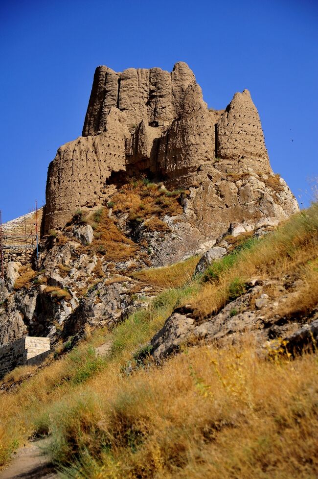 ワン城はBC834年、ウラルトゥ王国のサルドゥール?世により建てられました。<br />ほぼ東西に伸びる細い岩山の上に造営され、長さ1500m、高さ80m、幅70mほどです。<br /><br />画像をご覧いただければわかるように、現在はほとんど崩壊しており原型はほとんど遺されていません。<br />遺構と言うのが相応しい状態です。<br />建材は石灰石のブロックと言われていますが、自然石を精緻に組み上げた構造は、山の下に一部残る石組みを除いては、ほとんど見られません。<br />むしろ日干し煉瓦を泥または素朴な漆喰で積み上げたように見える遺構が多く、これが保存状態が悪い理由のひとつと推測されます。しかし土に還りゆく遺跡としての趣はあります。<br />またワンの街と、ワン湖、特にワン湖へのサンセットの展望台として価値がありそうです。<br />