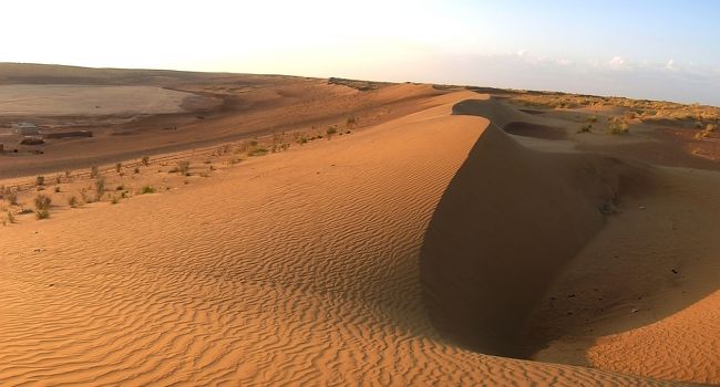 今回のトルクメニスタン旅行の３つの目玉のうちの１つがこのダムラ村でした。（他の２つは「地獄の門（ガス・クレーター）」と「ヤンギ・カラ」。）。<br />掲載した略図にもあるように、ここは、カラクム砂漠のど真ん中にあります。途中、大砂丘を横断したり、かつてアムダリア川がカスピ海に注いでいた時の河床を通過するなど、冒険ムードにあふれた旅となりました。<br /><br />ネット地図ではダムラ村の名前は表示されていないと思いますが、デジカメのGPSによれば、露営地は北緯40°01′17″、東経59°13′37″となっていました。国道の分岐点から休憩を入れて6時間、隣の村から1時間ほど離れた砂漠のど真ん中にあり、大型トラックでたまに物資を輸送する以外には外の世界との交流は殆ど無いように思われました。<br />新型の感染症が世界中に蔓延して人類が絶滅の危機にさらされたとしても、ここだけは生き残るかもしれません。