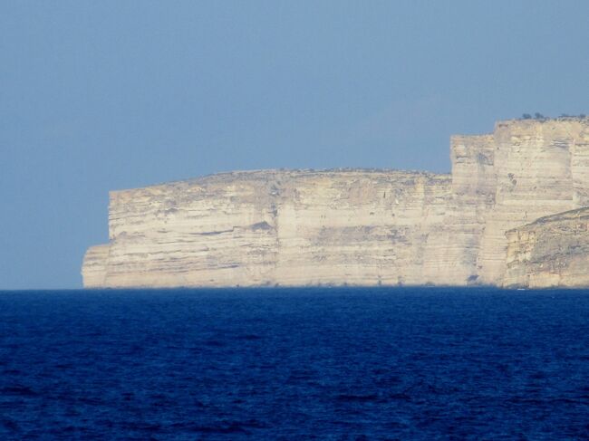 マルタ島からフェリーで約２５分。行く途中にブルーラグーンで有名なコミノ島もある。自然の景勝地としてアズール ウインドウ。世界最古の遺跡としてジュガンディーヤ神殿。天井がドーム型に見えるだまし絵のヴィクトリア大聖堂などがある。この写真の「アズール・ウィンドウ」が嵐の影響で２０１７年３月８日朝に崩壊したらしい。