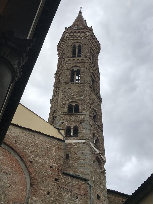 表紙の写真・インフェルノのロケ地の「Badia Fiorentina」バディア・フィオレンティーナ教会の鐘楼(月曜日・15時~18時のみ入場可能)<br />1310~再建された高さ70メートルの鐘楼。<br /><br />「お断り・ピサ・ルッカは数枚のみで、別旅行記にしました」<br /><br />2019・5月20日(月)夫は初めはピサは行かなくて良いと言いましたのに、途中からやっぱりピサの斜塔は見てみたいと言い出して、慌ててルート変更。<br />私が前回行きそびれたルッカ・フィオレンティーナ教会を入れ込んだ為、結構タイトな観光になりましたが・・ボローニャより満足な1日でした。<br /><br />次の電車チケットは前日にネット購入。夜遅くまで時刻表をにらめっこして、各地に最低限の滞在ですが行ける時間を選びました。<br />2017年の一人旅時には、窓口・券売機で購入していましたが、今回はネット購入の簡単さ・券売機周りの危険さなど、お勧めの購入方法を選択。<br />(もちろん、近場の短距離チケット・長距離は早得がお値打ちです)<br /><br />①ボローニャ7:40~フィレンツェ8:15「ホテルに荷物を預けてピサへ」<br />②フィレンツェ9:28~ピサ10:28。<br />③ピサ12:20~ルッカ12:47。<br />④ルッカ14:31~フィレンツェ15:50。<br />⑤フィレンツェ・フィオレンティーナ教会訪問。<br /><br />2017年9月の訪問時に予定していたのに、久しぶりのフィレンツェの路地で迷って訪問出来なかった、ローマへ戻る途中にフィオレンティーナ教会訪問がメインのフィレンツェ再訪でした。<br />前回もわざわざ月曜日に設定したのに(汗)・・今回もバッチリ月曜に設定してあります^^<br /><br />「フィオレンティーナ教会」<br />信者の皆様のご奉仕の受付の感じで、3ユーロの入場料が要りました。<br /><br />ダンテは思い人ベアトリーチェと初めてあったのが、このフィオレンティーナ教会だとしているとか・・<br />この教会の開基に関わったのは10世紀のトスカーナ候ウーゴだそうです。<br /><br />祭壇横の階段から修道院のオレンジの回廊に出れます。<br />2層になった回廊には「聖ベネディクトゥスの生涯」が描かれたフレスコ画を拝見させて頂けます。<br />聖ベネディクトゥスは6世紀半ば亡くなった聖人だそうだそうで、西欧の修道院の原型を作った人物。<br />