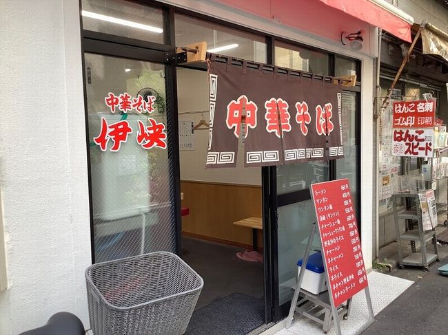 神保町1丁目北側で店を営んでいたラーメンの老舗“伊峡”が4月に一旦店を畳んでの移転先は、同じく神保町1丁目南側。三省堂裏のすずらん通りから一筋南に入ったところで6月から営業を再開しました。<br /><br />そしてようやく、4年ぶりに懐かしい味との再開を果たしました。お品書きにあるとおり、ラーメン1杯450円。かつては380円という時代もありましたし、その昔はもっと安かったはずです。<br /><br />そんな値段のゆえか、トッピング(チャーシュー、メンマ、海苔)はシンプルというよりも、もう少しあってほしいなという量ですが、東京風細打ち麵とスープの味は変わらず健在。<br /><br />どうぞ末永く神保町でラーメンを食べさせてください。