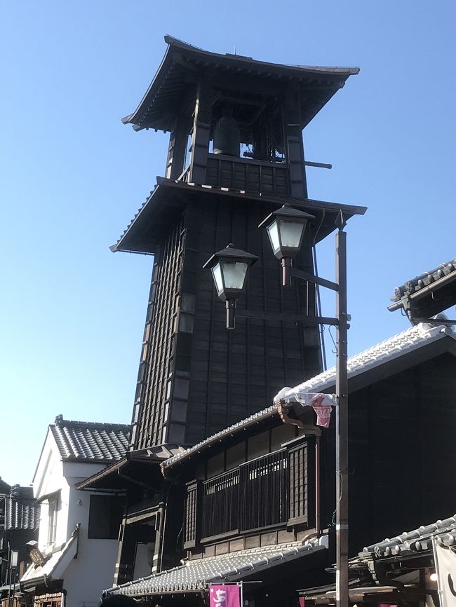 2月10日の月曜日、ちょうど連休の谷間にあたるこの日を利用して、都心からもほど近い武州「川越」の街並みを歩いてみた。<br />暦の上では既に立春を過ぎたものの、まだまだ寒い日が続く毎日ではあるが、今日は大変に天気も良く、また思ったわりには暖かく、過ごしやすい、街歩きをしやすい一日だった。<br /><br />さて、武州川越の散策は西武新宿線の終点の駅である「本川越」から始まった。<br />本川越の駅には西武新宿駅と同様、駅ビルの「PePe」や「プリンスホテル」などもある。<br />そして、ここを起点に、観光客の流れに沿って約15分ほど歩いていくと、やがてタイムスリップをしたかのように、古い蔵造りの街並みが広がることとなる。電信柱は全て地中化され、それこそ行き交う車が邪魔にも感じられるくらいの街並みが続いていた。<br /><br />一つ一つの建屋が非常に重厚な感じがするし、また、この街並を和服姿で歩く女性らも多く、なんともこの街並みに華を添えている。<br />やがて、ひときわ目立つ高い建物が見えてきたが、これがこの街のシンボル的存在とも言える「時の鐘」と呼ばれる建物で、平日ではあるものの、多くの人でにぎわっていた。<br /><br />また、全く別の話しではあるが、この街は「鰻」を食べさせる老舗が多く並んでおり、それも特徴の一つかもしれない。<br />街を散策していると、どこからともなく鰻につきものの、独特の「たれ」の匂いが自然としてきて、なんとも食欲をそそられる。<br />でも、今回は敢えて「鰻」は外し、「うな丼」ではなく、これまた行列を作るほどの人気店「OHANA」さんの「親子丼」を食してみた。<br />なかなかの美味!<br /><br />そして、お腹を満たした後は、そのお店の前から始まる「大正ロマン通り」を歩きながら「成田山川越別院」を参詣した。川越散策と言えば、有名な「喜多院」があるが、その参道の入口、つまり喜多院の横に位置する寺院である。<br /><br />今回はあまり多くを周った訳ではないが、ぶらぶらと、まるでタイムスリップをしたかのような街並をゆっくりと歩き、途中でお昼を食べ、最終的にはJRや東武東上線の駅となる「川越」駅まで戻ってきた。往路は西武線を利用したので、復路は東武線を使ってみようと考えたためである。乗り心地を比べるために...(笑)<br /><br />なお、最後に、川越駅の西口からほど近い場所にある「ウニクス川越」に立ち寄ってみた。<br />ここは多目的ホールと複合型ショッピング施設がコラボしており、またその一角には観光案内所らしき場所があって、まさに秋にこの地で開催される、勇壮な山車がいくつも繰り出す「川越まつり」の映像を紹介していた。<br /><br />都心から電車にて1時間弱・・・、今度はこのお祭りをゆっくりと観に出掛けるのも良いと思う。<br />皆さんもちょっと気分転換をしたいと思ったら、気軽に出掛けることのできる、この趣きのある「川越」の街を訪れてみるのも一興ではなかろうか?<br /><br />そう言えば、サツマイモもこの地の名物で、これを活かした美味しいお菓子も色々と売られていたし、それを求める若いカップルの仲睦まじい姿も大変に印象的な街であった。<br />因みに、マスコットキャラクターも、このサツマイモをモチーフにしていたのは言うまでもない。