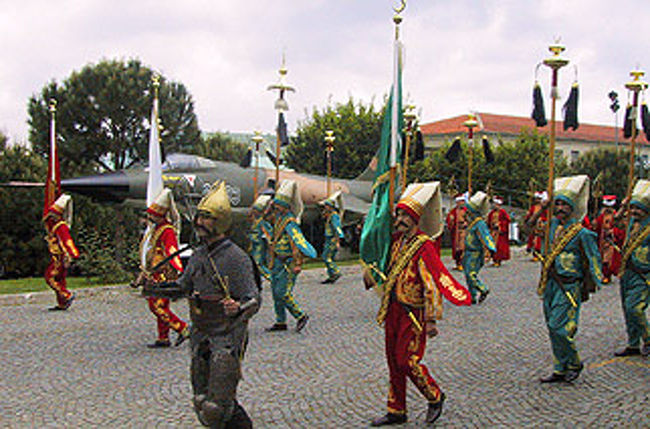 戦闘機の前を行進する