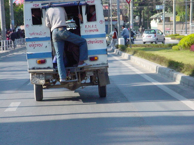 テンプー（後ろ）（カトマンズ市内）<br /><br />●いかに多くの乗客を呼び込むかが助手の腕の見せ所です。自分の居場所はどこにでも。