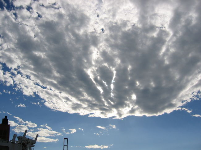 乗船前の空：台風が去った後でした。下を向いた時にバイクの燃料タンクに映っていた。