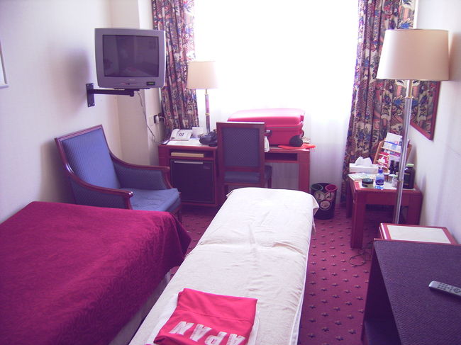 ちょっと露出が狂ってて、赤っぽく、眩しく写ってしまいました。真ん中のベッドは当方で持ちこんだものです。でも、ベッドを置くと、これくらい狭いというのが分かるかも知れませんね。<br /><br />窓は大きくて、それこそ一面、窓です。採光は抜群です。窓は開きますから、朝は気持ちいい空気の入れ換えができます。