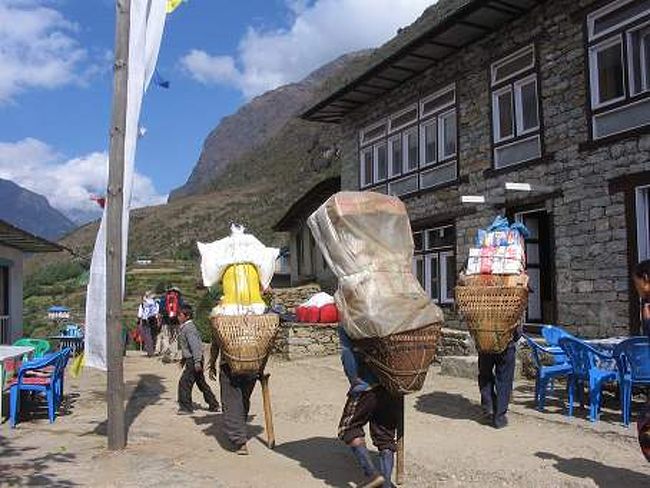 荷物を担いで歩くシェルパの人々<br />すごい荷物の量に驚かされます。