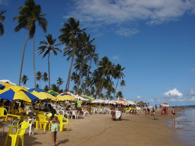 サルバドールには海水浴場がたくさんあります。<br />それぞれに名前がついています。<br />ここは地元の人たちがよくいく庶民的なビーチ、GUARAJUBA（ガラジューバ）です。<br />海にはパラソルつきのテーブルがたくさんたててあり、座るとすぐメニューをもったお店の人がやってきます。<br />ガラナジュースやカニを注文しておしゃべりをしながら日長一日すごすのがブラジルの週末の過ごし方。<br />水は透き通っていてぬるく、遠浅なので泳ぐのにもってこいです。<br />寝そべっても高い並みは来ませんのでぬるいお風呂につかっているような気分があじわえます。