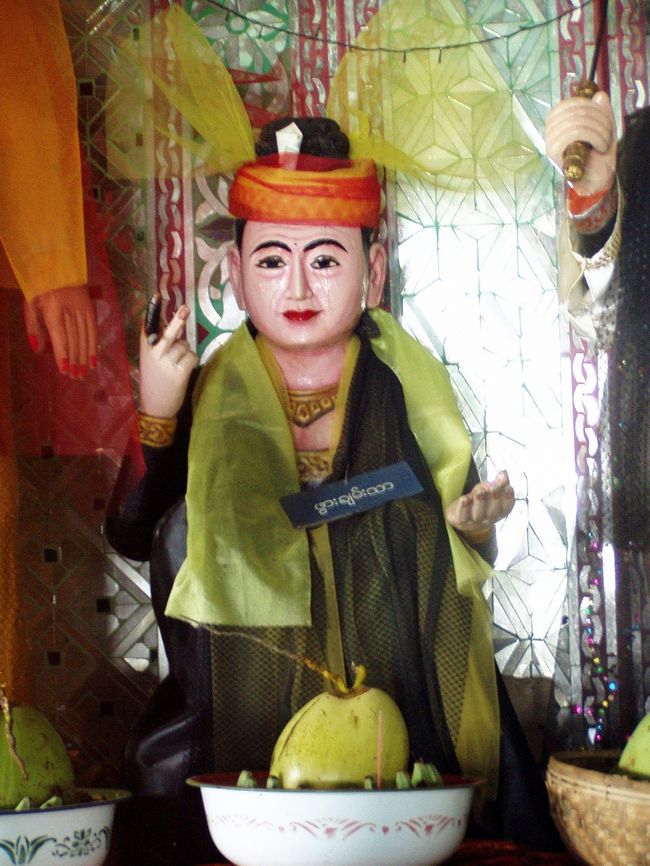 「一個二百チャットでけっこうです」．．．てなわけないけど。<br /><br />　頂上に行くまでにいくつか祠があって、神様が祀らせている。しかし、どれもこれもマネキンっぽくっていっこうに有り難味が湧いてこない。神社仏閣仏様は古ぼけている方が有り難味を感じると、幼い頃から刷り込まれている僕にとって、ミャンマーの神様はおっさんの模型にしか見えないのだ。<br />　このような神様と一緒に仏像も祀られていたりして、どうなってんの？　という疑念もふと浮かんできた。後でウィンウィンにこの疑問をぶつけたら、ナッ神と仏教両方の聖地だからという答えが返ってきた。要するに鳥居の奥に仏様がいらっしゃるということになってしまっているのだ。日本人の宗教心もかなりいいかげんだが、ミャンマー人のそれもなかなかだ。確かに精霊信仰とは言っても日本の神道みたく神主さんがいて、格式ばった儀式があるわけではなく、大衆の信仰心がよりどころみたいなものだから、有り難いものは全部一緒に．．．という気持ちがあっても不思議ではない気もする。