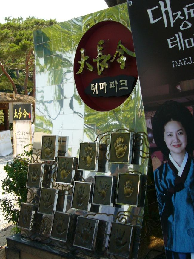 ソウル市内から約１時間でテーマパークに到着。道中チャングムのＤＶＤが流れ気分を盛り上げてくれました。入り口に設けられている出演者達の手形。ハングル文字で名前が書かれているため誰の手形かわかりません。