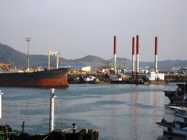 右手に見える紅白に塗り分けられた4本のポールは、一体なんでしょうか？港湾作業に必要なもののようですが、見当が付きません。