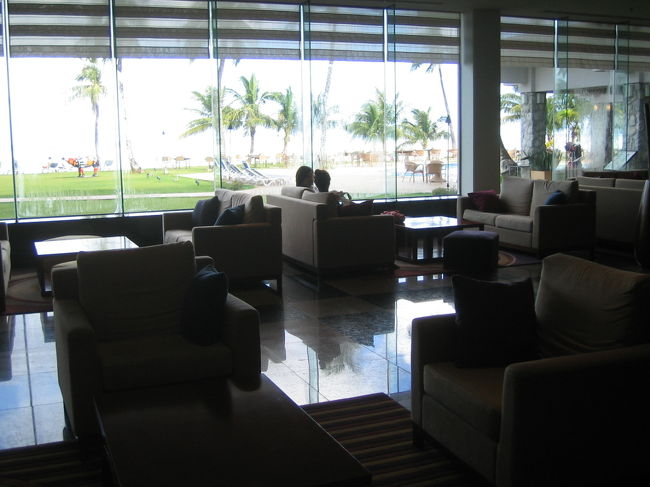 【ホテルへチェックイン】<br />グアム到着後、ベビーカーをレンタルして（JTBのツアーで無料）、送迎バスでホテルへ。<br />今回の滞在先は、「フィエスタリゾートグアム」。<br />「アウトリガー」や「ウエスティン」のような華やかさなく、実際かなりリーズナブルなのですが、海に近いのがウリのホテルです。<br />部屋から水着のままプールやプライベートビーチに出ることができるので、子連れにはとても便利。<br />毎晩開催される@50ドルのポリネシアンBBQディナーショーも、余裕で遠巻きに見ることができます。<br /><br />しかし非常ーーに残念だったのは、私たちの部屋が海側でなかったこと！！<br />海側なら最高の景色が楽しめたはず。<br />でも陸側の部屋は、バルコニーもなく、フツーのビジネスホテルのような趣き。。<br />せっかくリゾートに来ているのだから、ちょっとくらい価格が上がってもビュー指定のあるホテルにすればよかったです。<br /><br /><br />＊写真／フィエスタリゾートのロビー。入った瞬間、海とプールが目に飛び込んで来ます。ビーチサイドでは、常にライブや生演奏があって優雅な雰囲気。