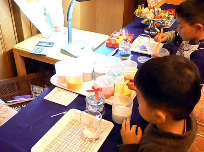 グラスに色々な色の付いた砂を何層にも敷き詰めて