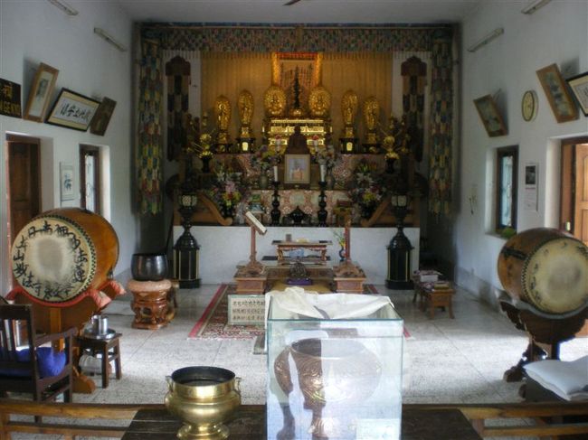 人懐こい犬が暑さを避けるためにお堂の中にねていました。