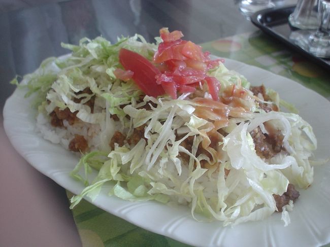 道の駅かでなの二階の<br />「ロータリー　ドライブイン　UP-KITTY」<br /><br />中華、沖縄料理、ハンバーガーなど<br />色々やってるレストランです。<br /><br />タコライス690円を注文。<br /><br />見てくれに洒落っ気はなし！<br /><br />熱々のご飯にタコスの具が<br />たっぷりのっていて、<br />その上にレタスたっぷりと<br />彩りでトマトが♪<br />お好みでタコスソースという<br />甘いチリソースがかけられます。<br /><br />これもまた旨い！<br />タコライスは初めて食べたけど<br />きっとここがNo.1！なんて勝手に思うほど<br />おいしかった！！<br /><br />