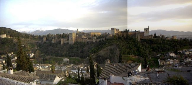 ４日目（３月１２日）後半　グラナダ<br /><br />サン・ニコラス展望台から（パノラマ合成）<br /> <br />セビリアからバスで３時間走ってようやく６時頃にアルパイシンに着いた。サン・ニコラス展望台から見たアルファンブラ宮殿の眺めはまさに絶景である。写真ではなかなかお伝えできないが、遠くに雪を被ったシェラネバダ山脈が見える。<br />